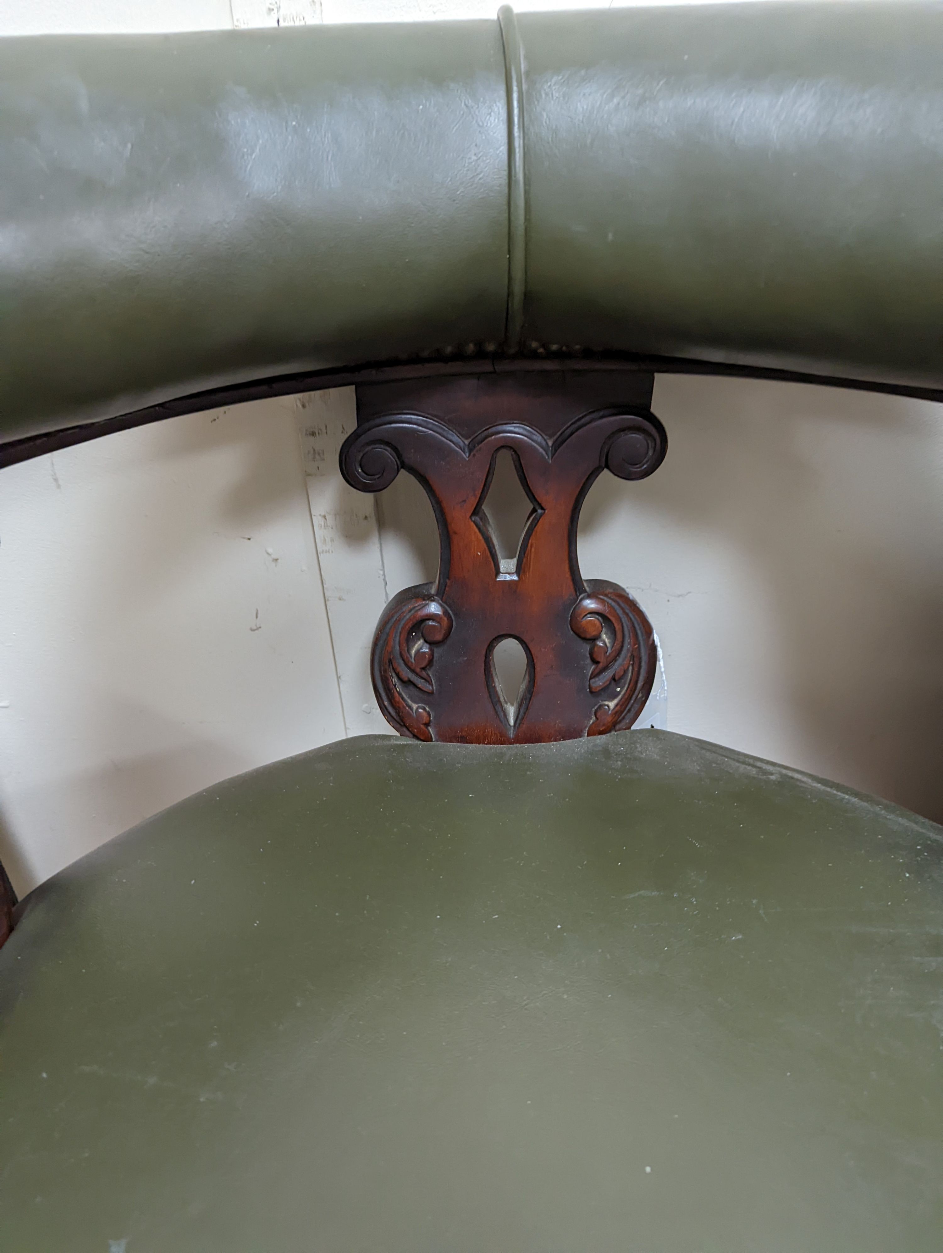 A Victorian mahogany tub framed chair upholstered in green leather, width 60cm, depth 58cm, height 66cm